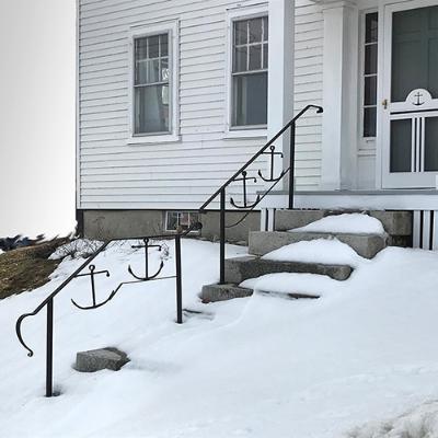 Wrough iron grill with flowers and glass balls.