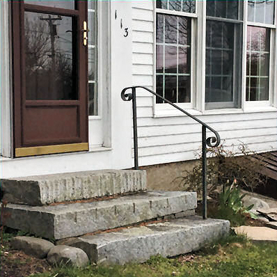 Simple railing along 3 granite block steps.