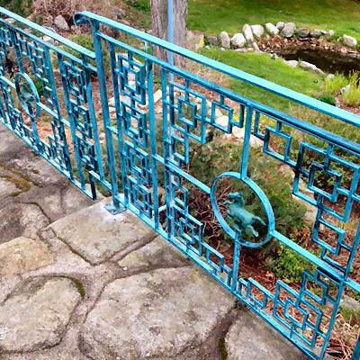 Gate with Asian styling with cast iron horses.